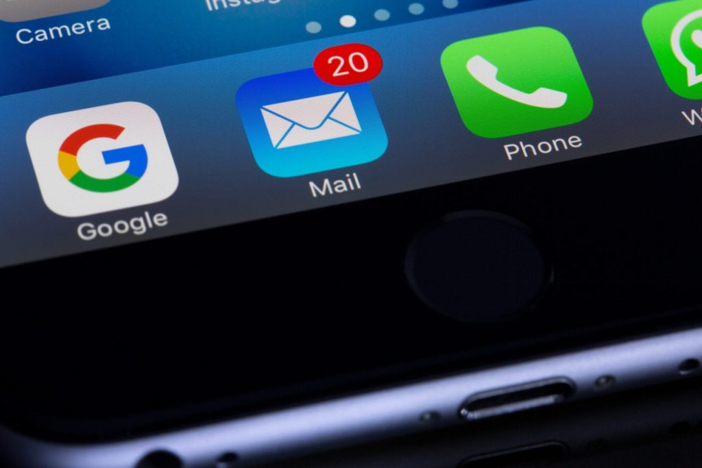 Closeup of an email icon with unread messages on an iphone.