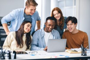 Image of a group of people watching a video on a laptop