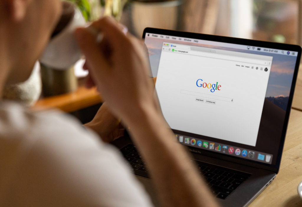 Image of a person conducting a Google search on a laptop