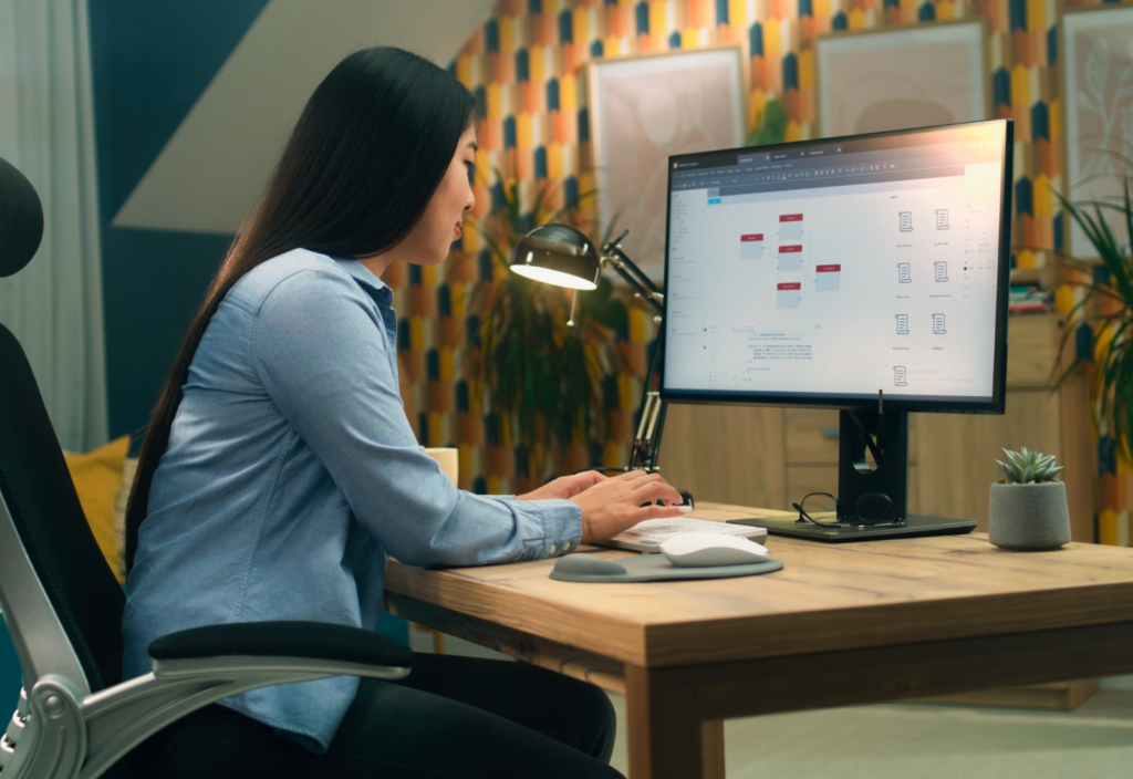 Image of a woman creating web copy on a desktop computer