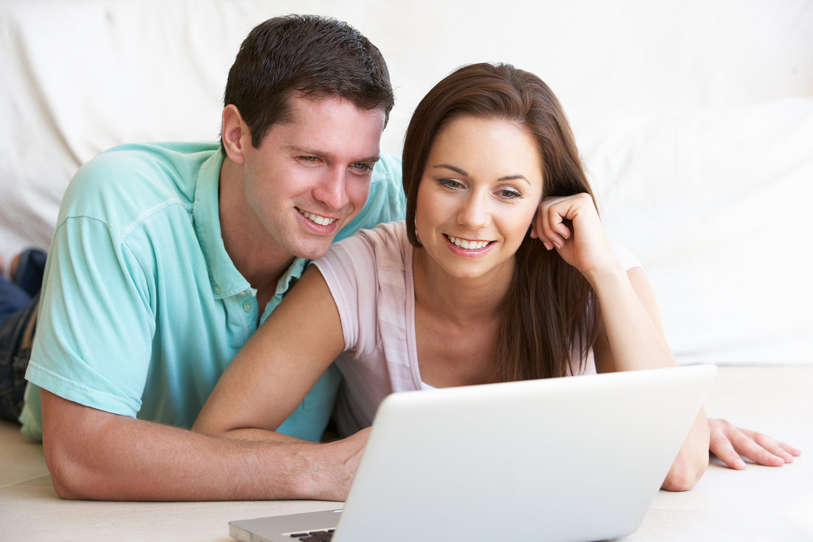 Image of two smiling people looking at a computer